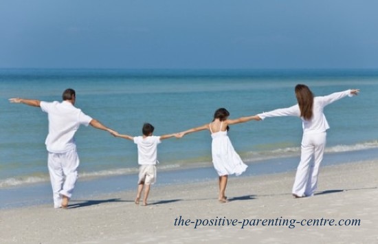the positive parenting centres Happy family walking on beach